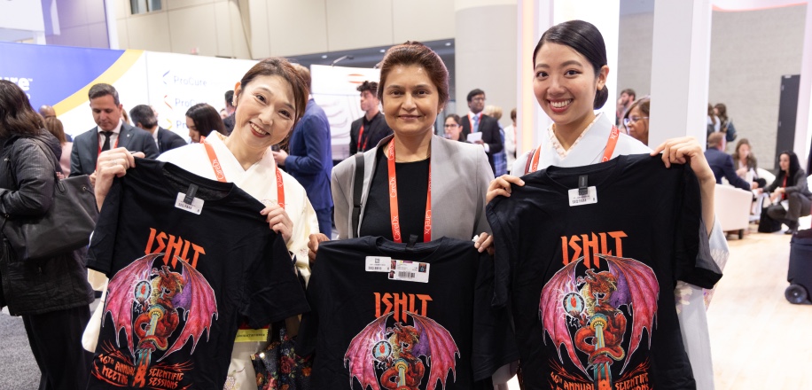Three women holding up their ISHLT2027 shirts