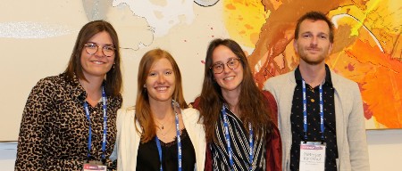 Four junior faculty smile for the camera at an ISHLT event