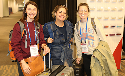 Photo of three people standing with luggage at ISHLT2023