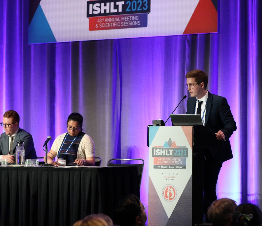 Photo of man presenting at podium during session at ISHLT2023 in Denver.