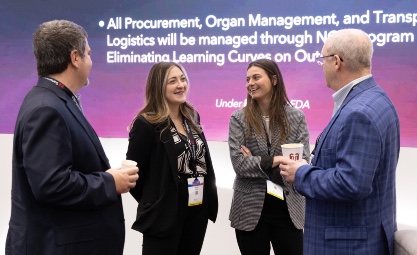 Photo of a group of ISHLT2025 Attendees talking in the exhibit hall