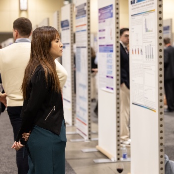 Photo of a woman looking at posters at ISHLT2026