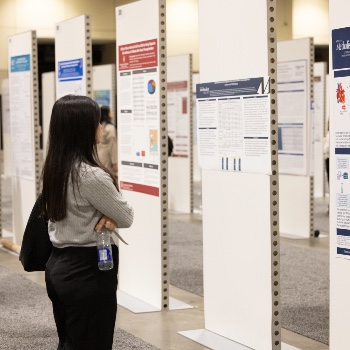 Photo of a woman looking at posters at ISHLT2027
