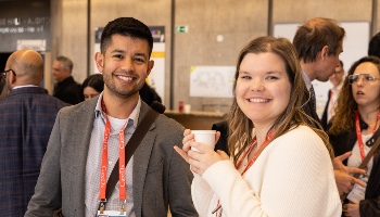 Two people standing together and smiling