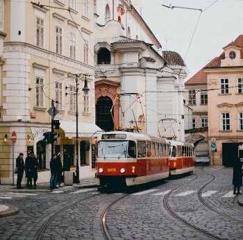 Photo of train moving through city streets