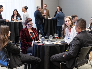 Four people sitting at a table having a discussion at the ISHLT2025 Early Career Reception