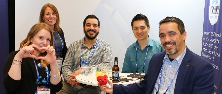 Exhibitors and attendees pose for the camera at an ISHLT event