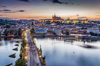 Photo of bridge over river with Prague in background