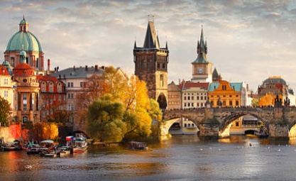 Photo of buildings and a bridge over a river in prague