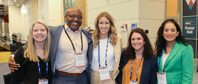 Five people posing for a photo at ISHLT2023 in Denver